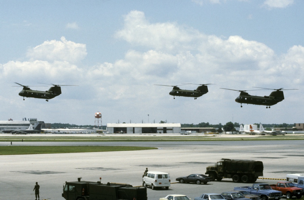 Three U.S. Marine Corps CH-46 Sea Knight helicopters hovering in formation at an air show